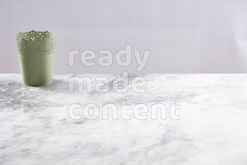An empty green plant pot on grey marble background