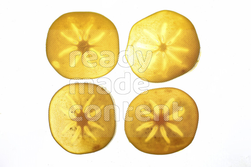 Persimmon slices on illuminated white background