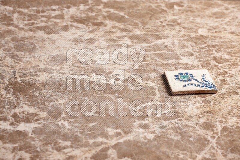 A decorative coaster on beige marble background
