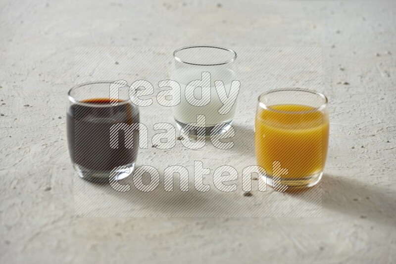 Cold drinks in a glass cup such as water, tamarind, qamar eldin, sobia, milk and hibiscus on textured white background