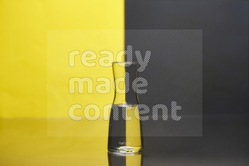 The image features a clear glassware filled with water, set against yellow and black background