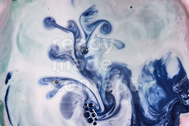 A close-up of abstract swirling patterns in red, green, white and blue