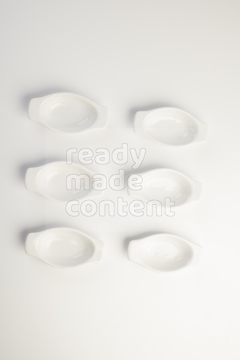 white ceramic oval sauce dish on white countertop