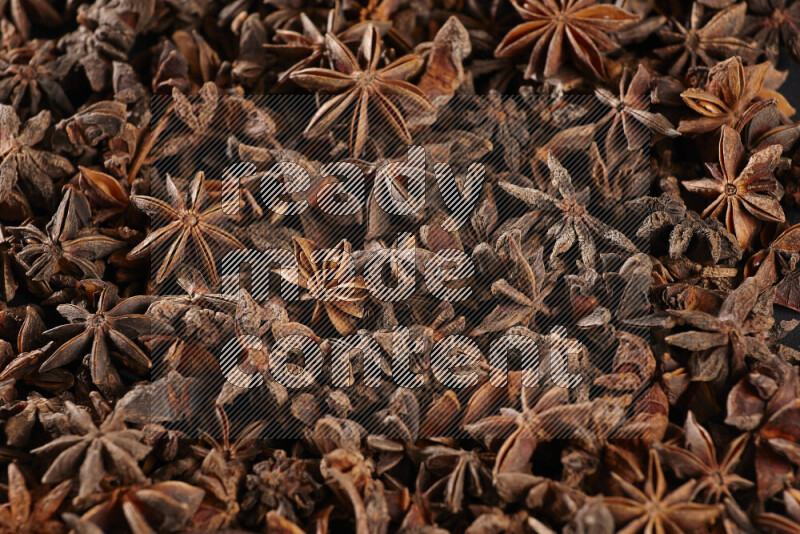 Star Anise fill the frame on black flooring