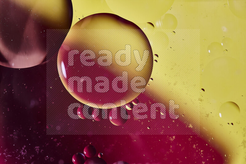 Close-ups of abstract oil bubbles on water surface in shades of red and yellow