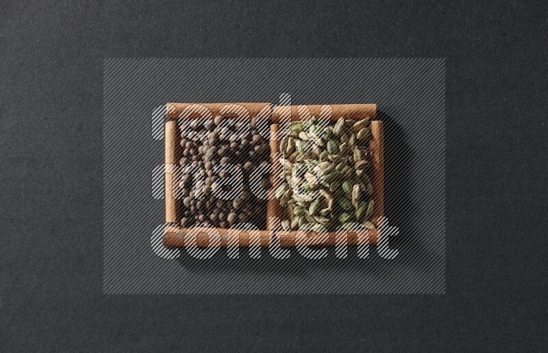 2 squares of cinnamon sticks full of allspice and cardamom on black flooring