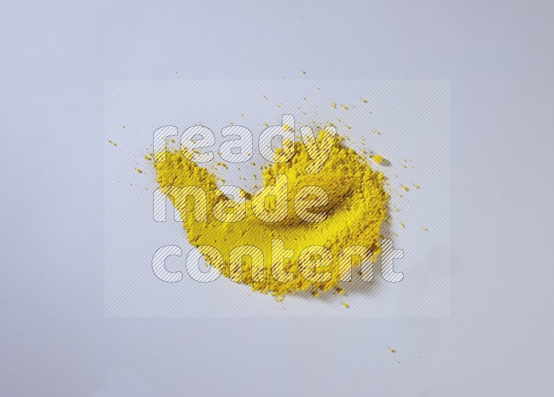 Yellow powder smears on white background
