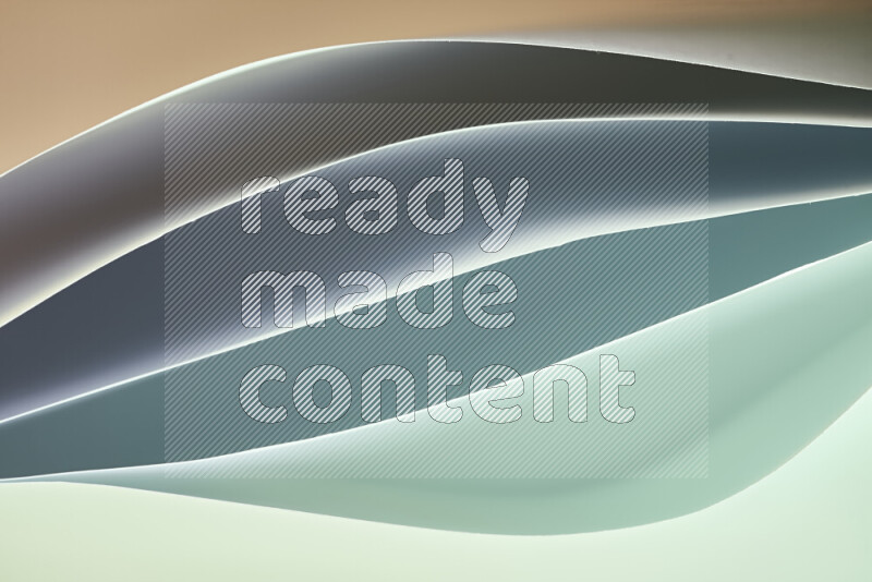 This image showcases an abstract paper art composition with paper curves in green and different warm gradients created by colored light