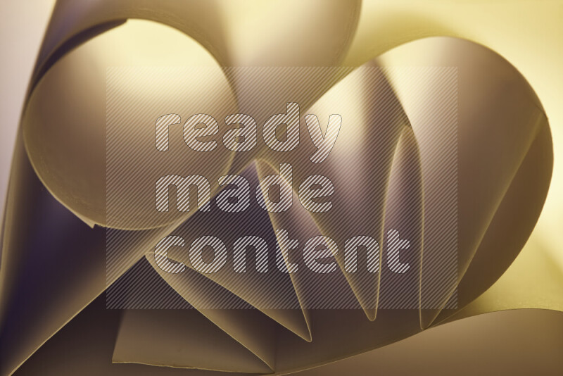 An artistic display of paper folds creating a harmonious blend of geometric shapes, highlighted by soft lighting in warm tones