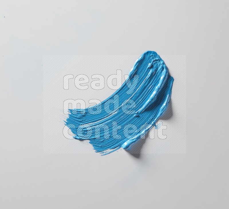 A single blue curved brush stroke on a white background