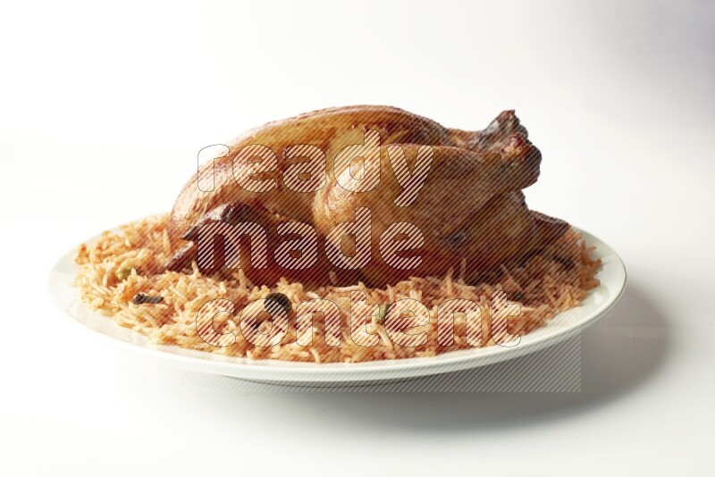 red basmati Rice with  whole roasted chicken on a white rounded plate  direct  on white background