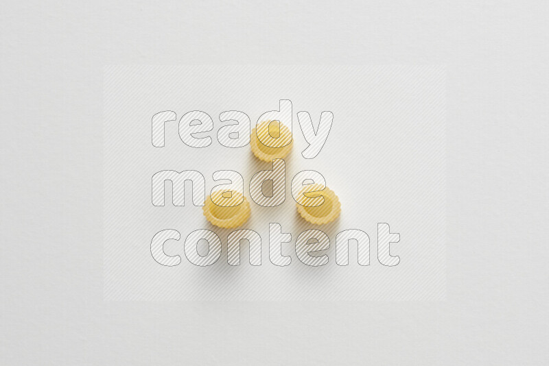 Big rings pasta on white background