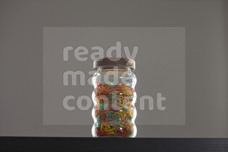 Snacks in a glass jar on black background