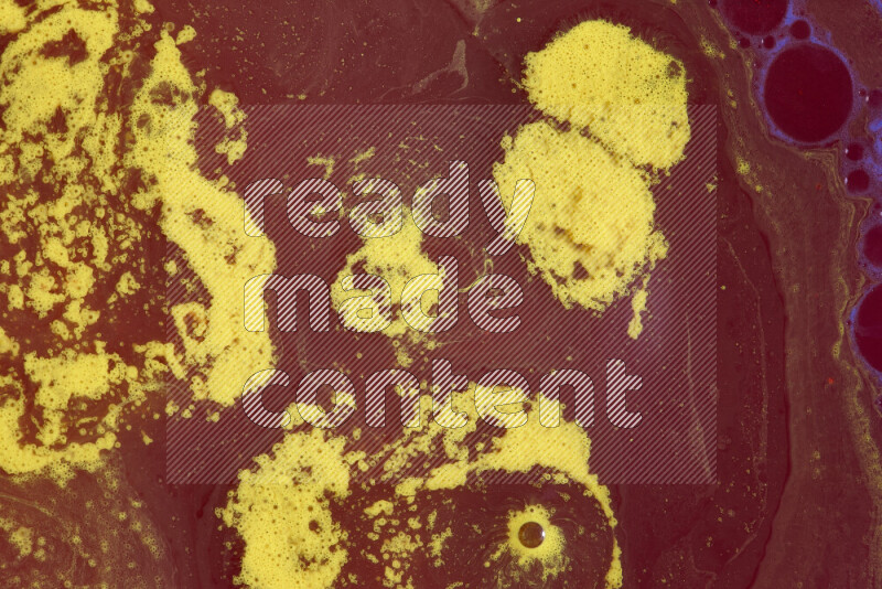 The image depicts a marbling effect with swirling patterns of red and yellow