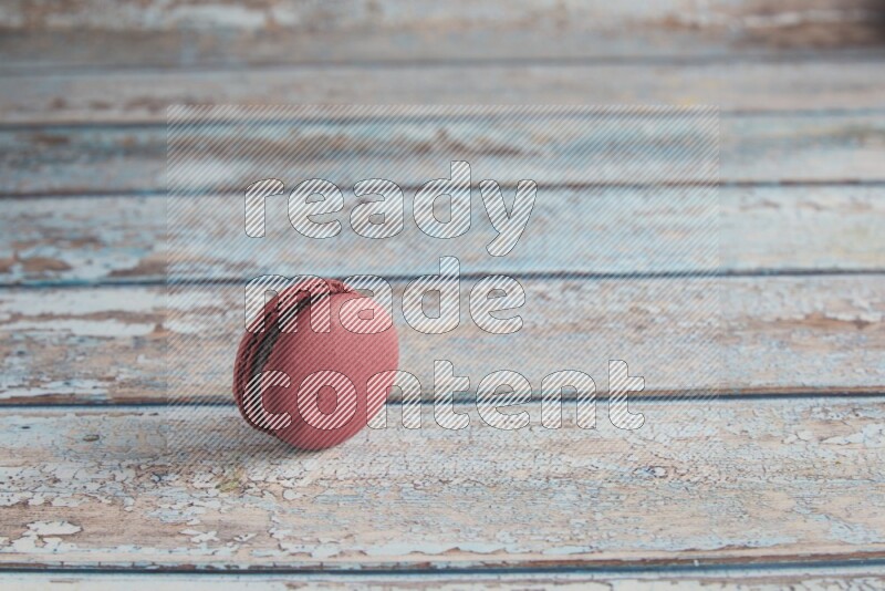 45º Shot of Red Cherry macaron on light blue wooden background