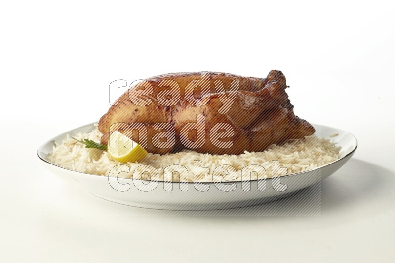 white  basmati Rice with  whole roasted chicken  on a white plate with a silver rim direct  on white background