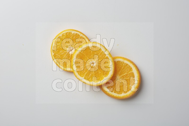 Three orange slices on a white background