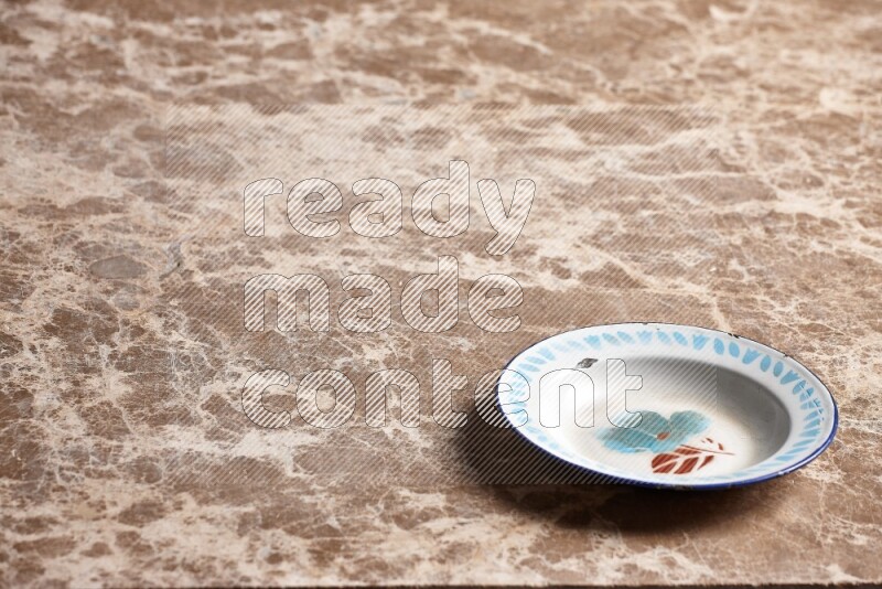 A vintage metal plate on beige marble background