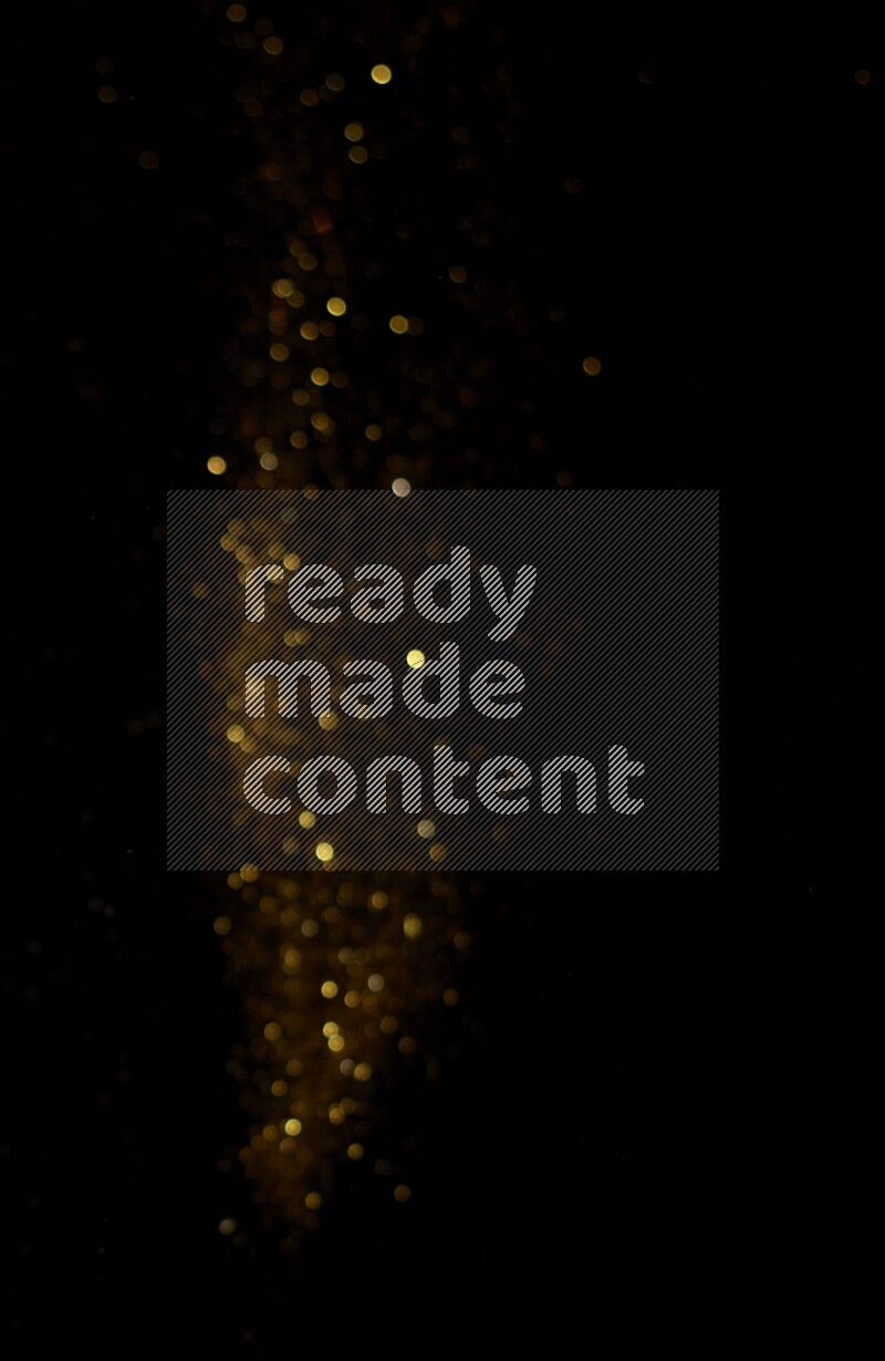 Gold glitter powder isolated on black background