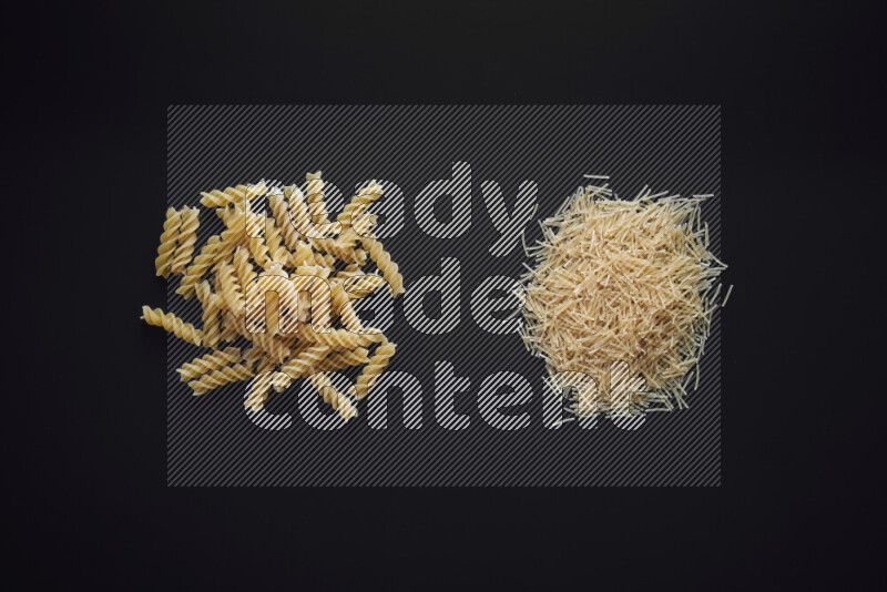 Different pasta types in bunches on black background