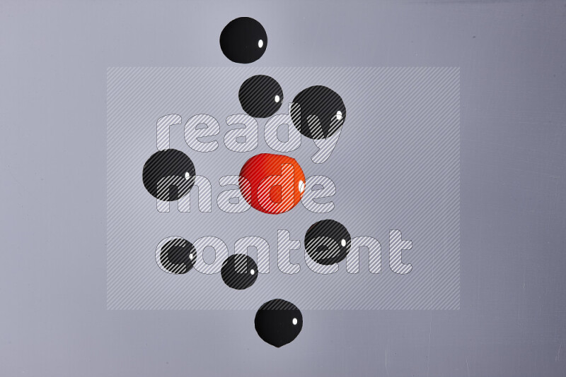 لقطات مقربة لقطرات من اللون الأحمر و الأسود على الخلفية