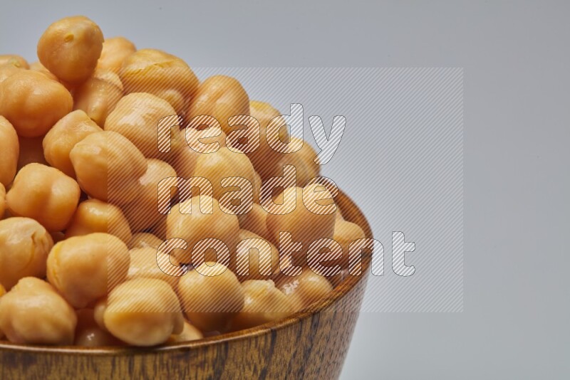Close up of a boiled chickpeas in a container on white background