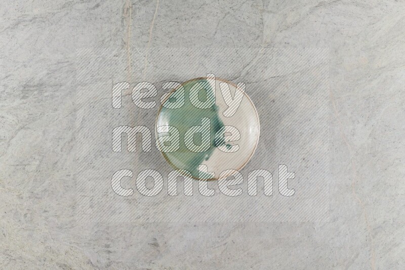 A multicolored pottery Bowl on grey marble background