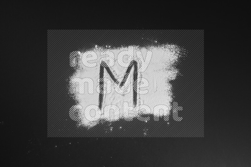 Alphabets written with powder on black background