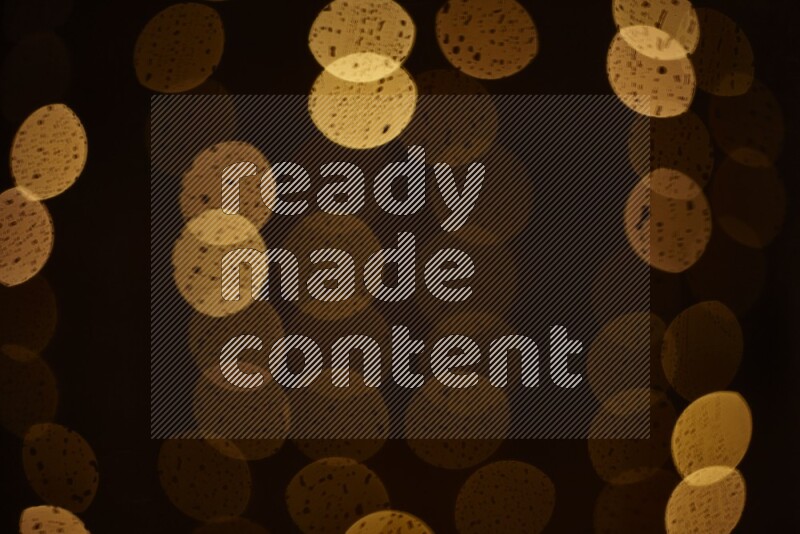 Bokeh light in yellow with water drops