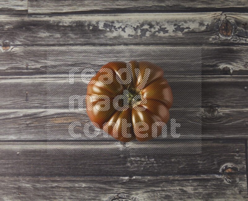 Single Tipview Heirloom Tomato on grey wooden background