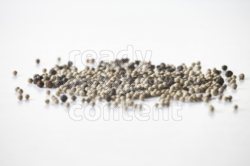 Mixed black and white pepper beads on a white flooring