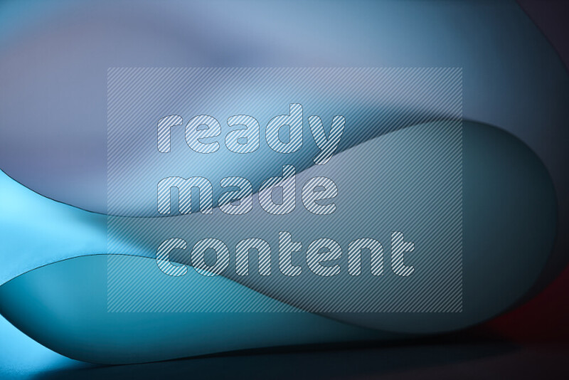 An abstract art piece displaying smooth curves in blue gradients created by colored light