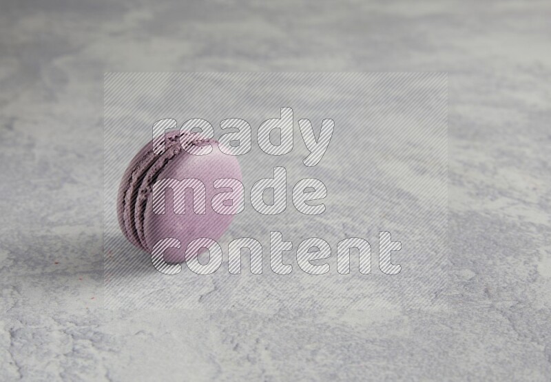 45º Shot of Purple Blueberry macaron on white  marble background