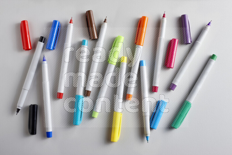 An arrangement of coloring pens in different colors on grey background