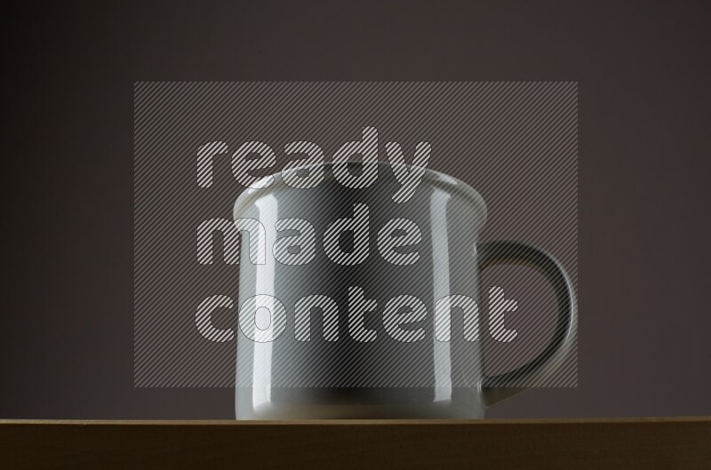 Low angle shot of a grey cup on grey background