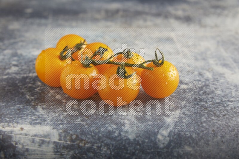 yellow cherry tomato vein on a textured rusty blue background 45 degree