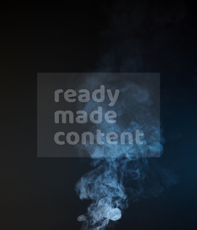 Heavy smoke in blue and yellow isolated on black background