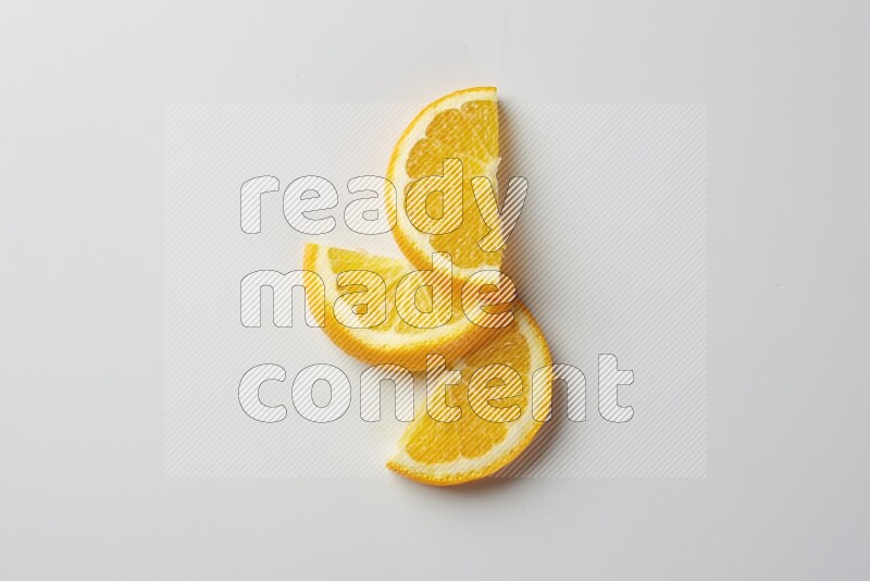 Three halves of an orange slices on white background