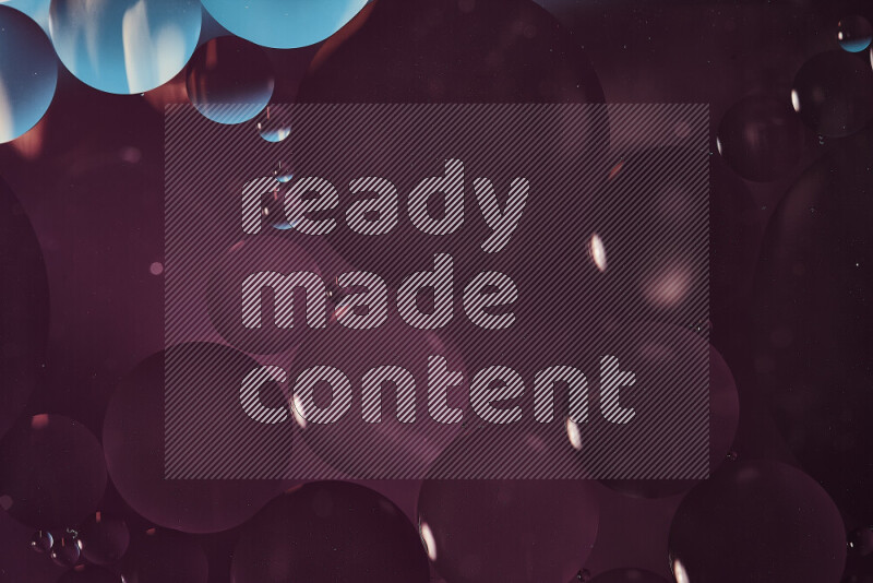 Close-ups of abstract oil bubbles on water surface in shades of blue and purple