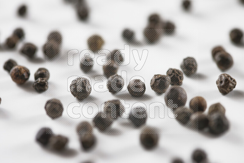 Black pepper beads on white background