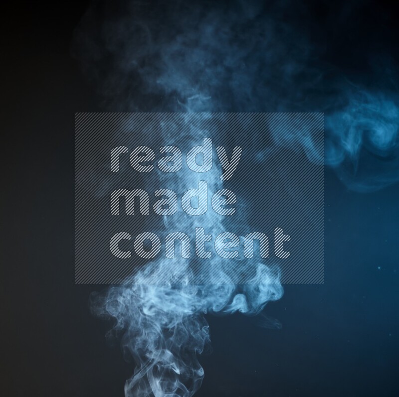 Heavy smoke in blue and yellow isolated on black background