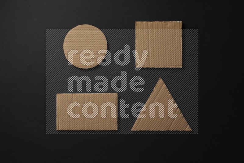 Cardboard in shapes on black background