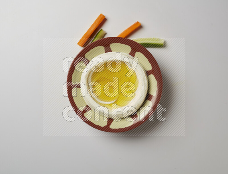 Lebnah garnished with olive oil in a traditional plate on a white background