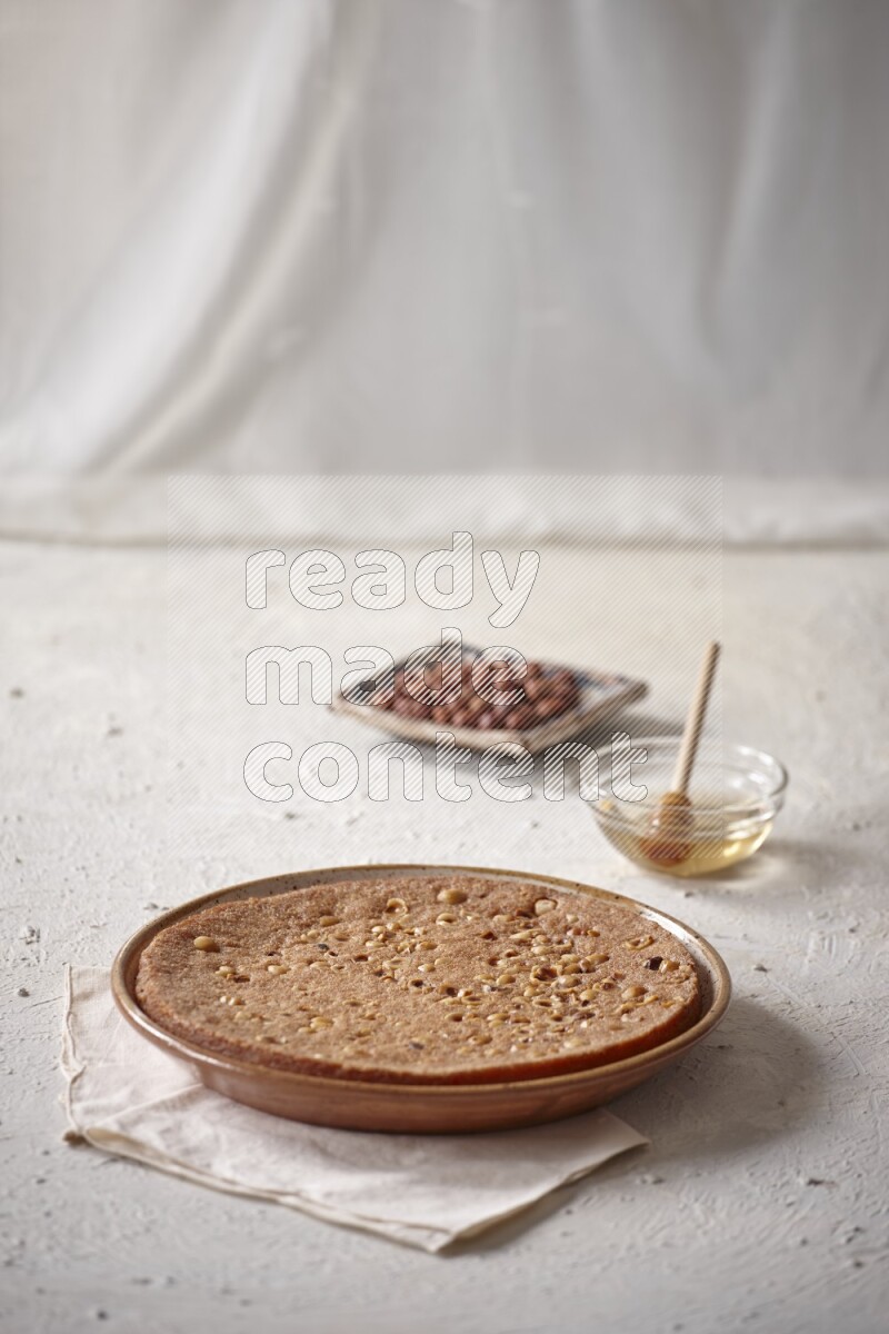 Basbousa with nuts and honey in a light setup