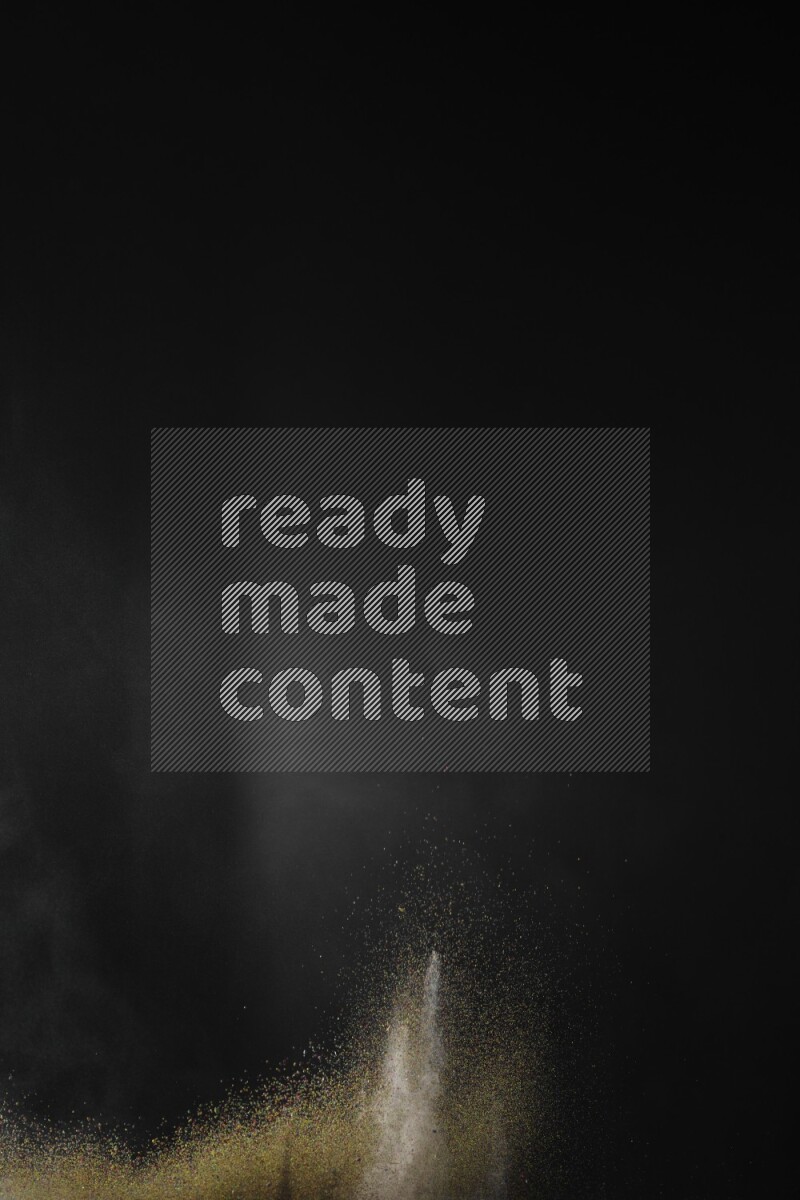A side view of brown powder explosion on black background
