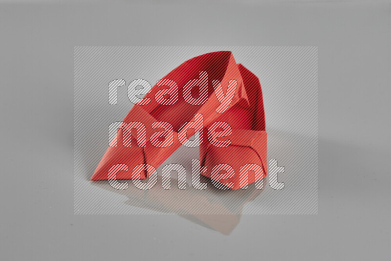 Origami shoes on grey background