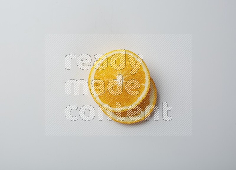 Two orange slices on white background