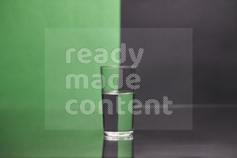 The image features a clear glassware filled with water, set against green and black background