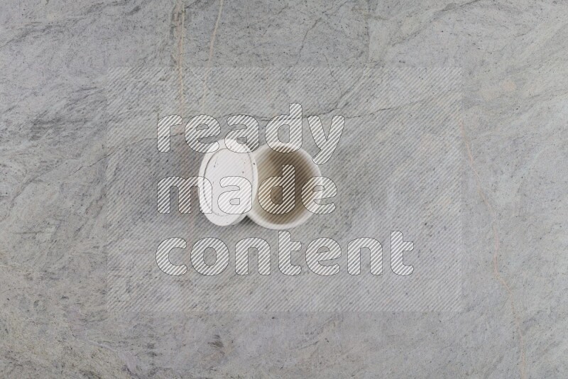 A multicolored pottery Cup on grey marble background