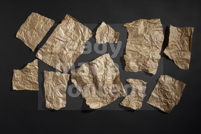 Crumpled craft paper on black background